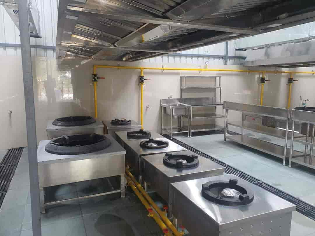 Commercial kitchen with gas bhatti stoves and yellow gas pipeline installed